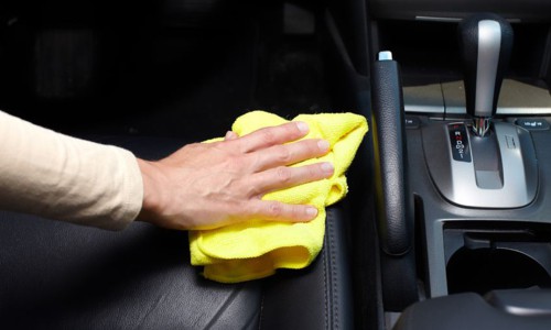 hand cleaning car interior