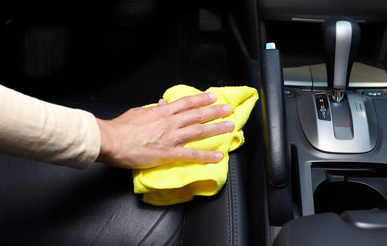 a man cleaning car interior by use foam chemical and scrubbing machine.  Stock Photo | Adobe Stock