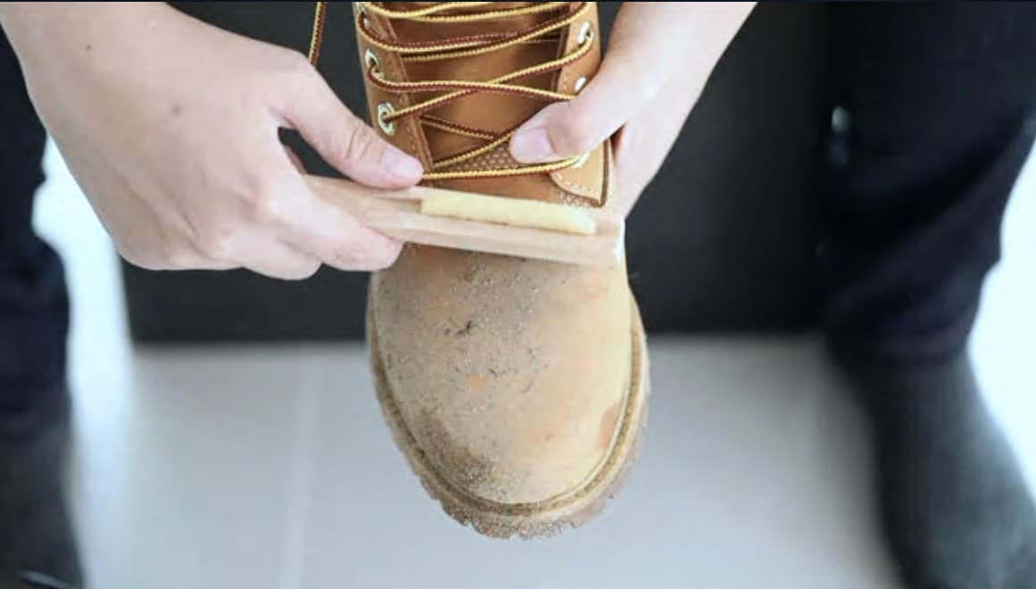 how to clean suede shoes man cleaning mud from work boot
