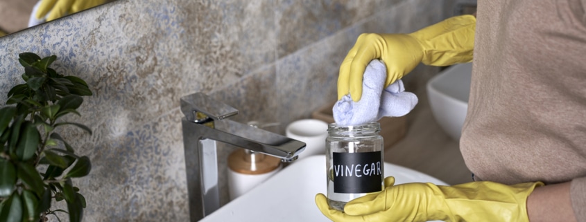 Unrecognizable woman cleaning with vinegar