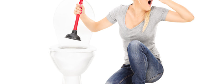 Woman unclogs a stinky toilet with plunger