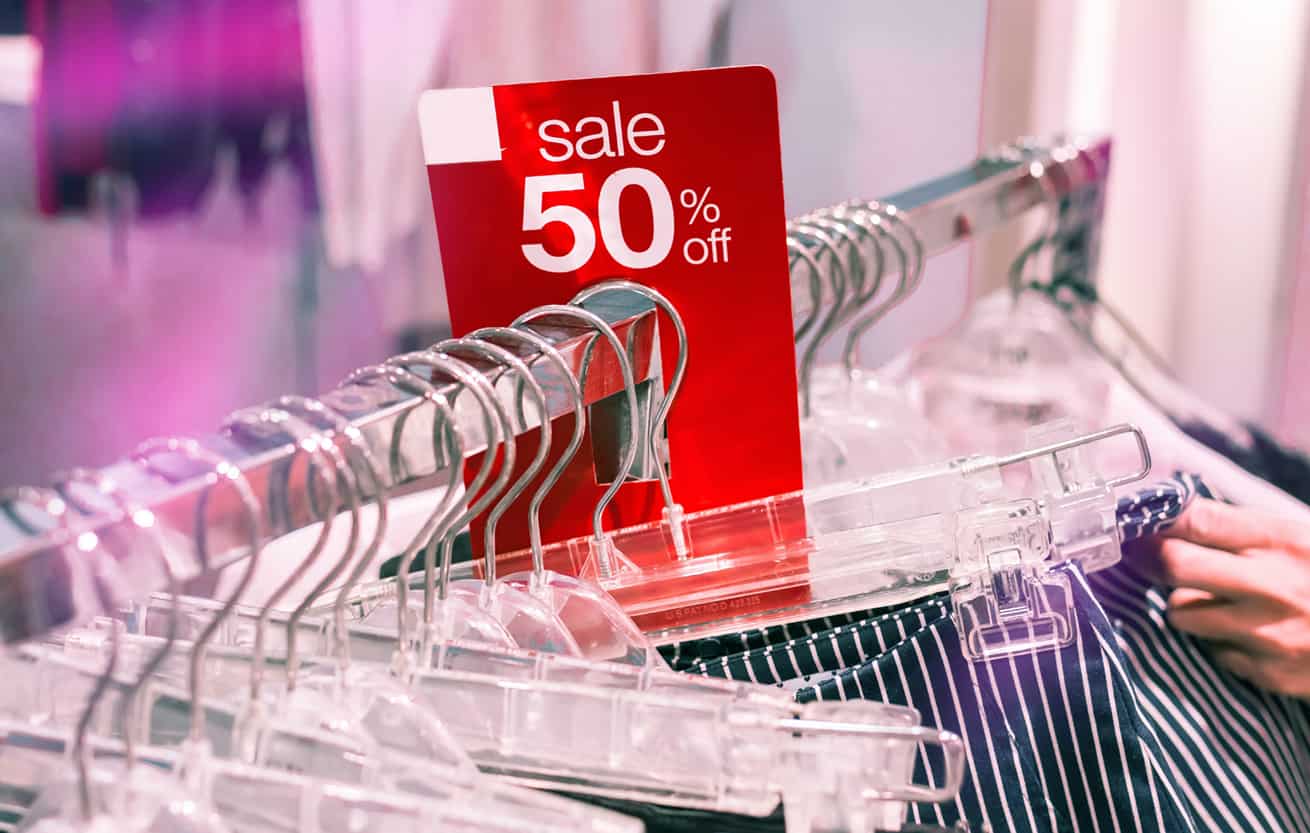clothes shopping in clothing store 50 percent off sale rack