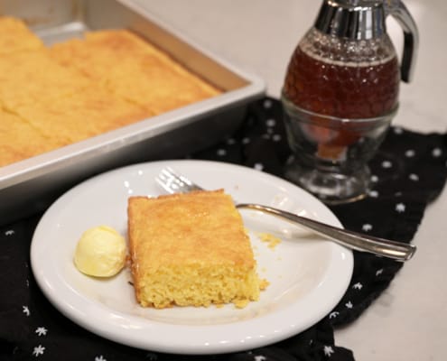 A plate of food on a table, with Cornbread