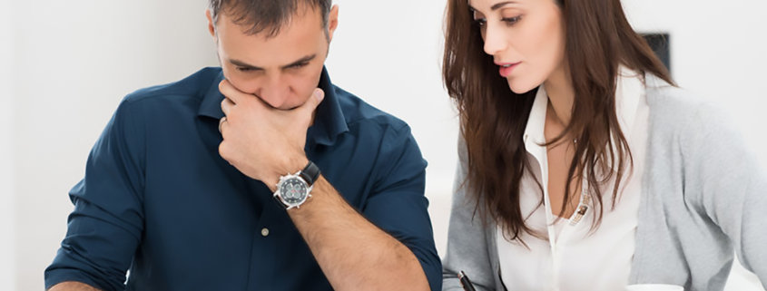 Portrait Of A Worried Couple Calculating Financial Budget