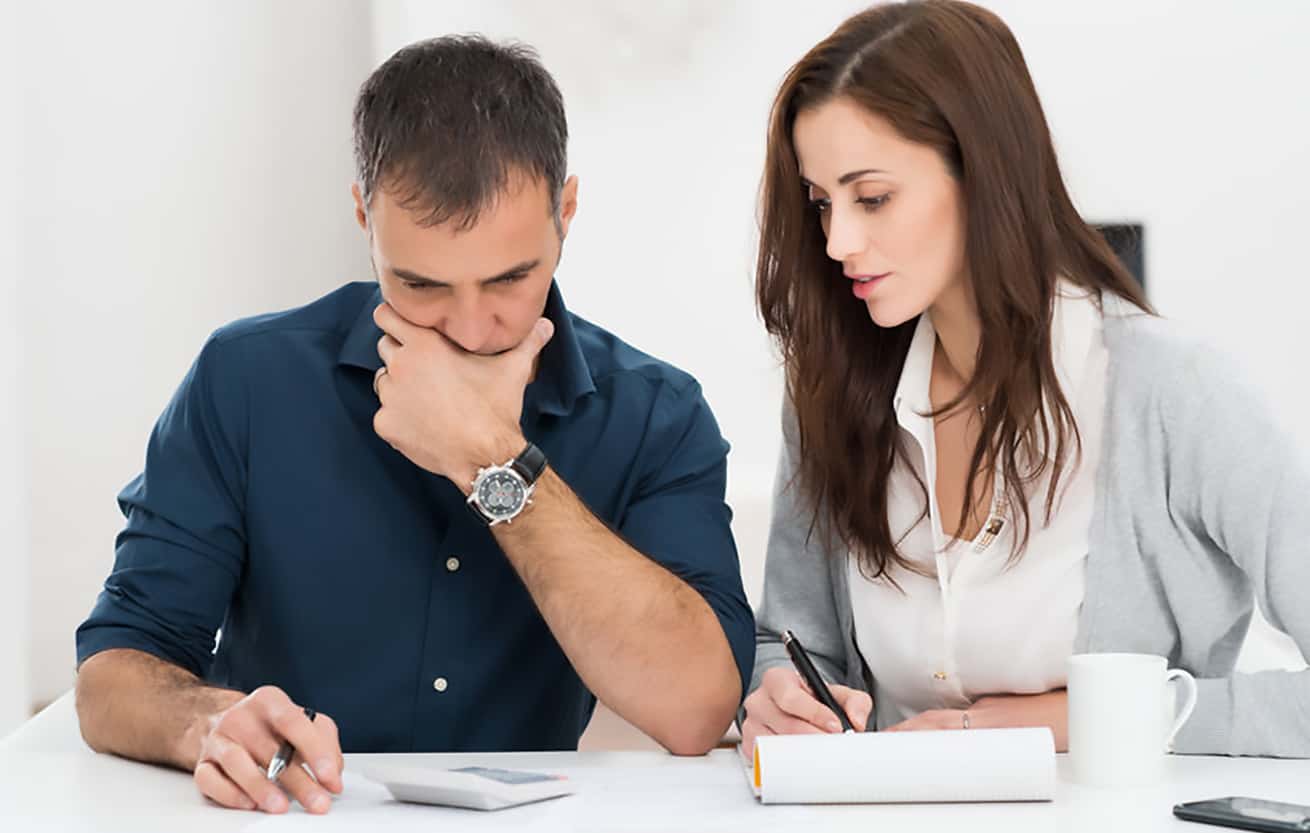 Portrait Of A Worried Couple Calculating Financial Budget
