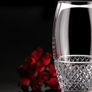 crystal drinking glass cleaned with denture tablet with red roses in background