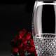 crystal drinking glass cleaned with denture tablet with red roses in background