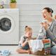 woman and child using fabric softener in laundry room