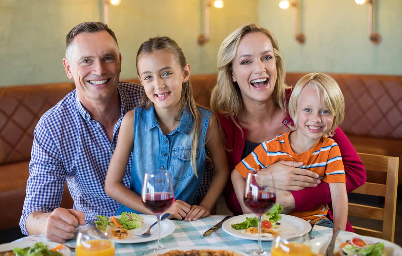 Portrait of cheerful family at restaurant