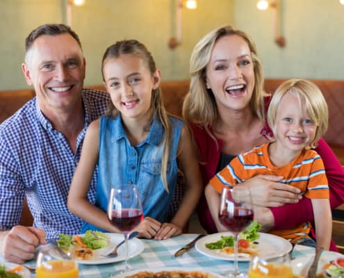 Portrait of cheerful family at restaurant