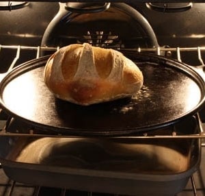A close up of a metal pan on a stove top oven, with Dough and Yeast