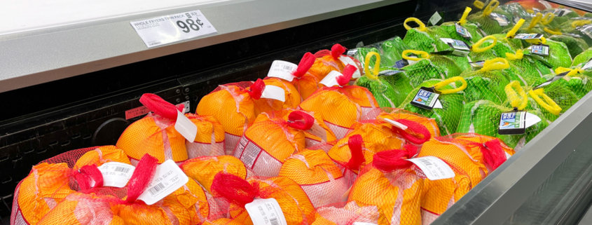 A display of frozen turkeys in the refrigerated meat aisle of a