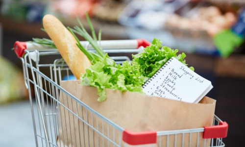 Background image of shopping cart with fresh groceries