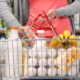 Woman holding basket with products at supermarket