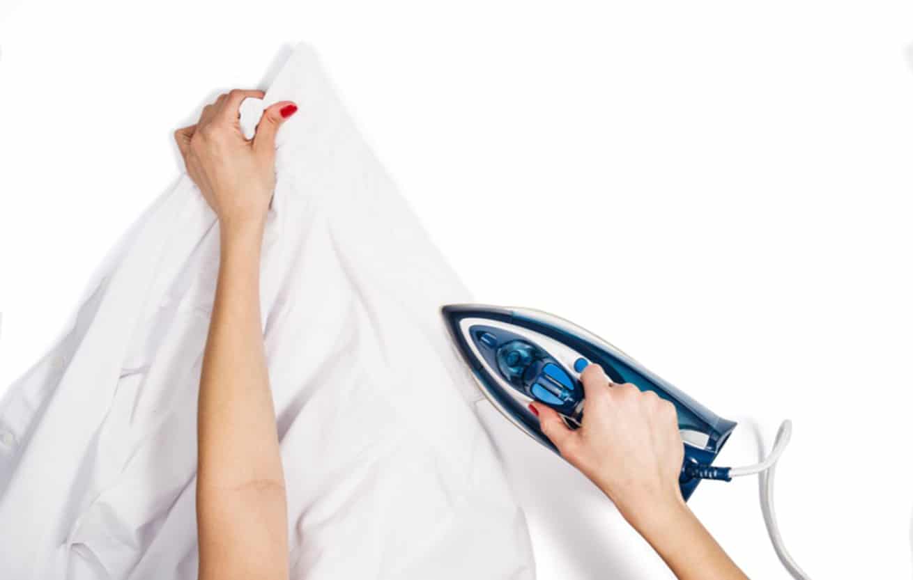 woman ironing man's shirt