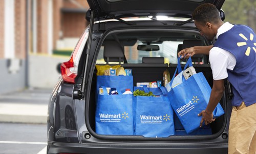 grocery shopping online from Walmart picking up groceries all loaded into the back of a car