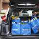 grocery shopping online from Walmart picking up groceries all loaded into the back of a car