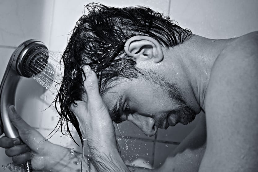 male in shower washing hair