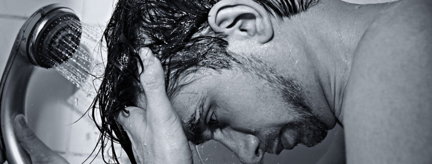 male in shower washing hair
