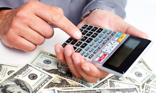 hand with a calculator. money saving concept.