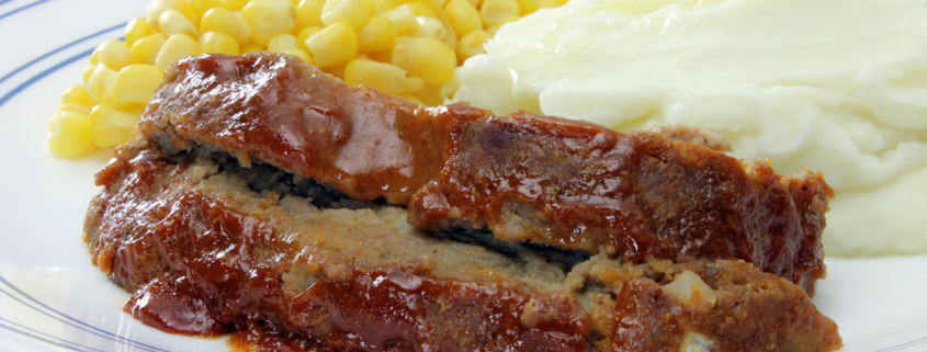 meat loaf on plate with potaotes and corn