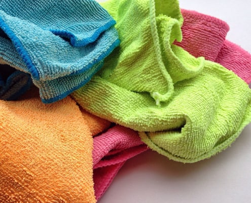bright colored cleaning cloths on white counter