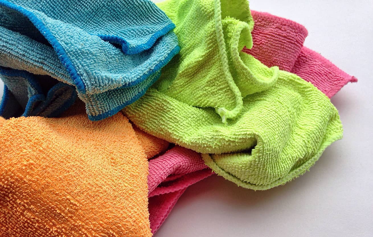 bright colored cleaning cloths on white counter