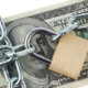 money under lock chain to show concept of retirement account