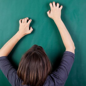 closeup rear view of frustrated woman scratching chalkboard