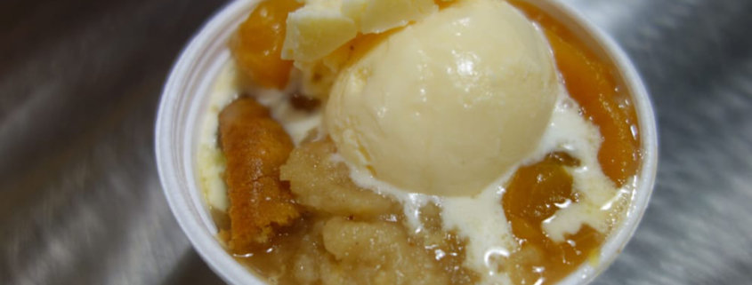 peach cobbler recipe in slow cooker and served up with ice cream