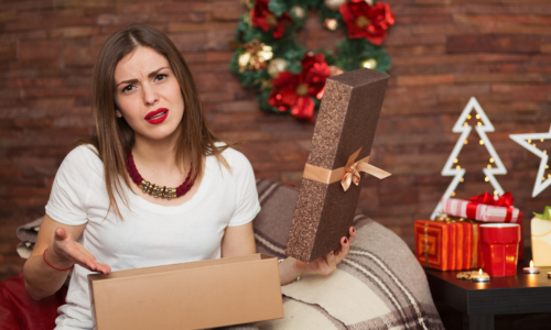disappointed woman opening a gift box for Christmas
