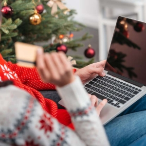 cropped shot of young couple shopping online with credit card and laptop at christmas
