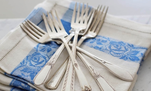 silver flatware forks on linen napkin