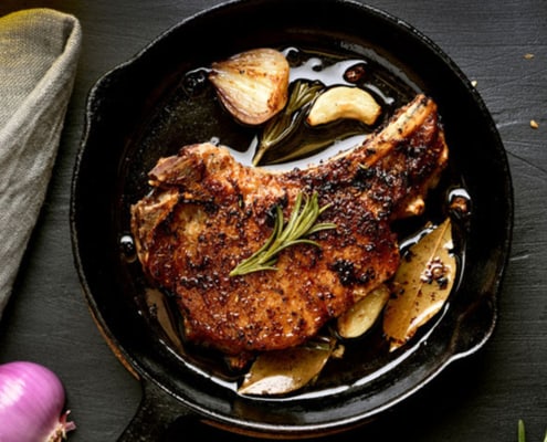 A pan of food on a plate, with Steak