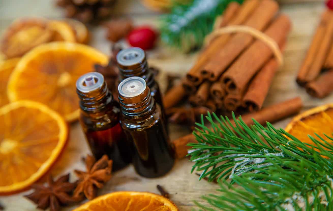 Christmas essential oils in small bottles. Selective focus. fresh smell fragrance stovetop simmer