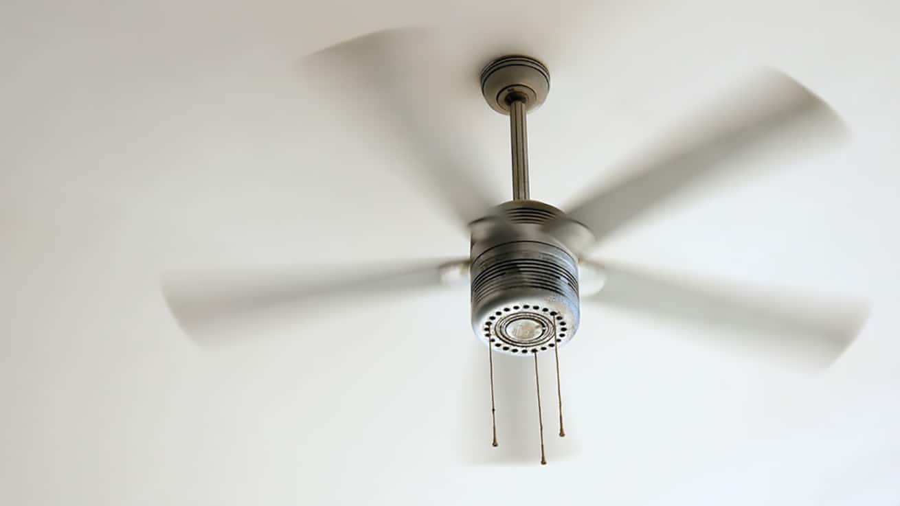 white Ceiling fan rotating against white ceiling
