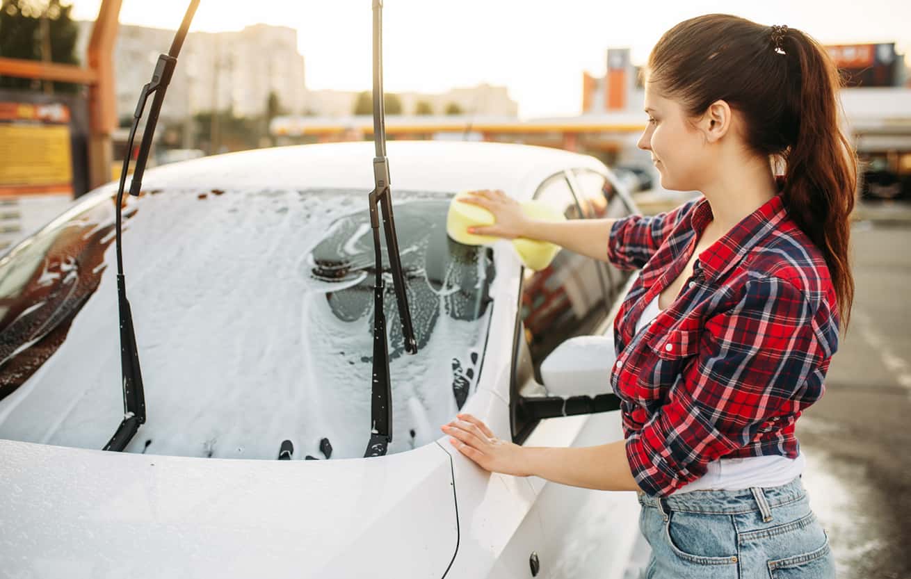 young woman washing her car