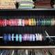 clever use of tension rods to organize spools of coloful ribbon