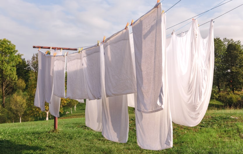 fresh clean white sheet drying on washing line in outdoor