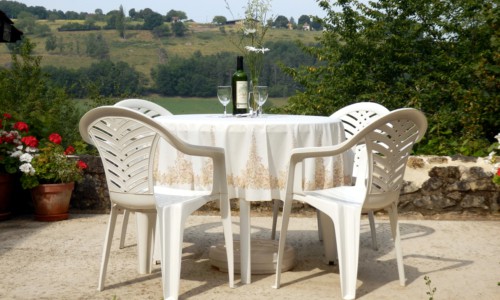 white plastic patio chairs and table