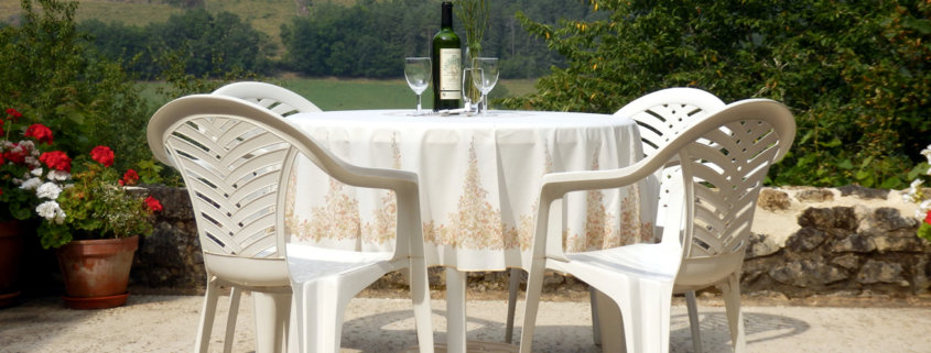 white plastic patio chairs and table