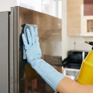 Woman cleaning refrigerator