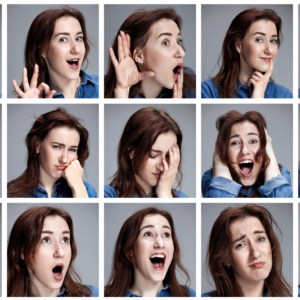 Set of young woman's portraits with different emotions on gray background